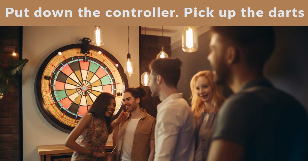 Millennials and Gen Z playing electronic darts together at home.