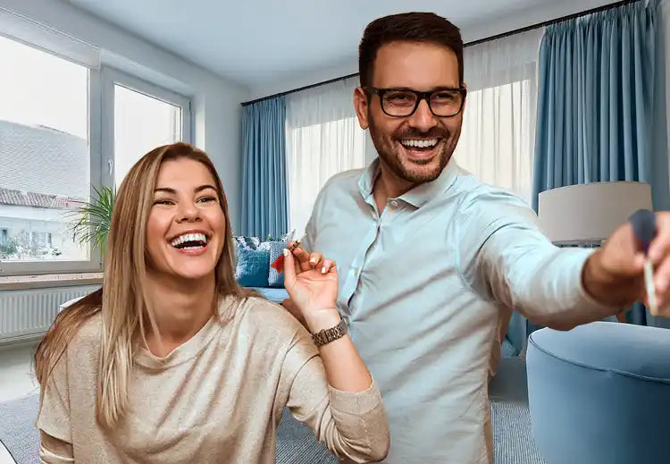 Laughing couple holding keys.